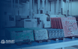 Multiple colored printed circuit boards (PCBs) organized on a workstation inside August Electronics' advanced manufacturing facility, highlighting high-mix, low-to-medium volume electronics production capabilities.