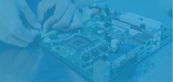 A blue-toned close-up of gloved hands assembling or repairing a circuit board.