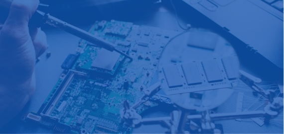 Soldering iron working on a circuit board under a magnifying glass on a helping-hands stand, shown in a blue tint.